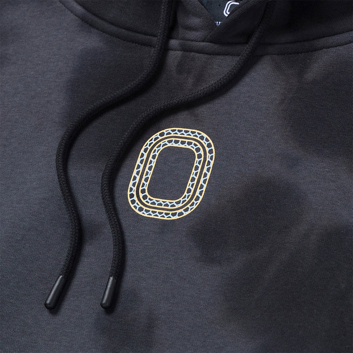 Up close view of emblem on the Overtime Aura Dye Hoodie.