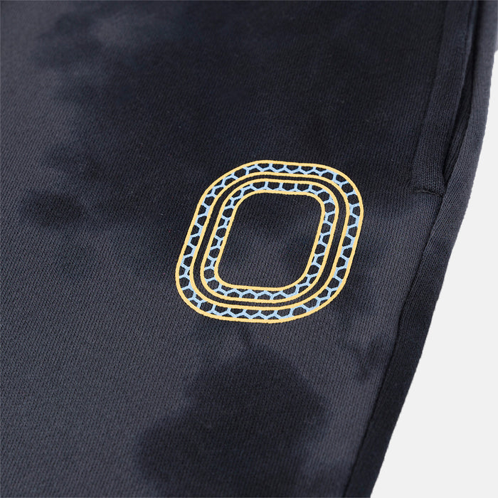Up close view of emblem on the Overtime Aura Dye Joggers.