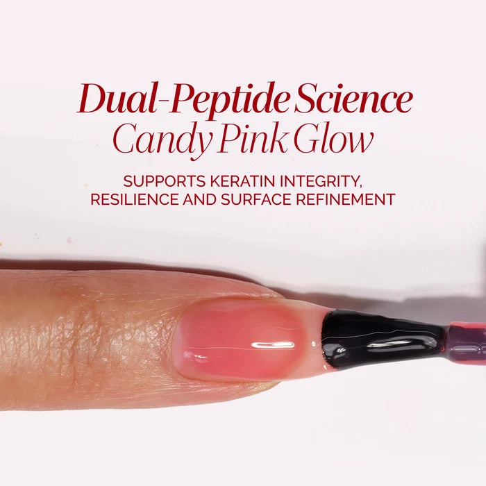 A fingernail being painted with sheer pink Bio Peptide Nail Glow, featuring text about keratin integrity, resilience, and surface refinement for glowing skin.