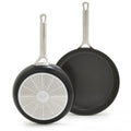 Set of two hard anodized frypans with silver handles and detailed bases, one 10-inch and one 12-inch.