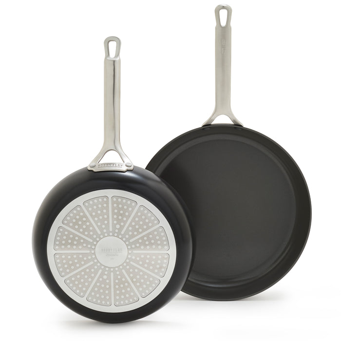 Set of two hard anodized frypans with silver handles and detailed bases, one 10-inch and one 12-inch.