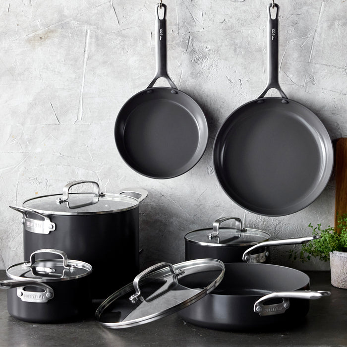 10-piece hard anodized cookware set with glass lids arranged on a kitchen counter.