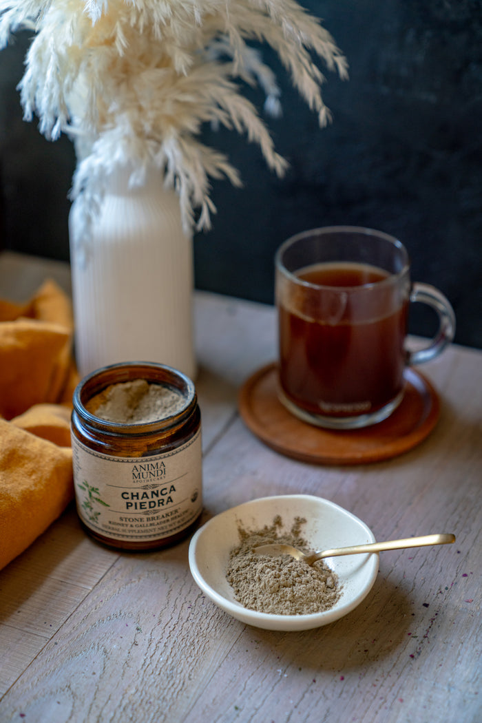 Tea cup, jar, and bowl on a wooden surface with decorative elements.