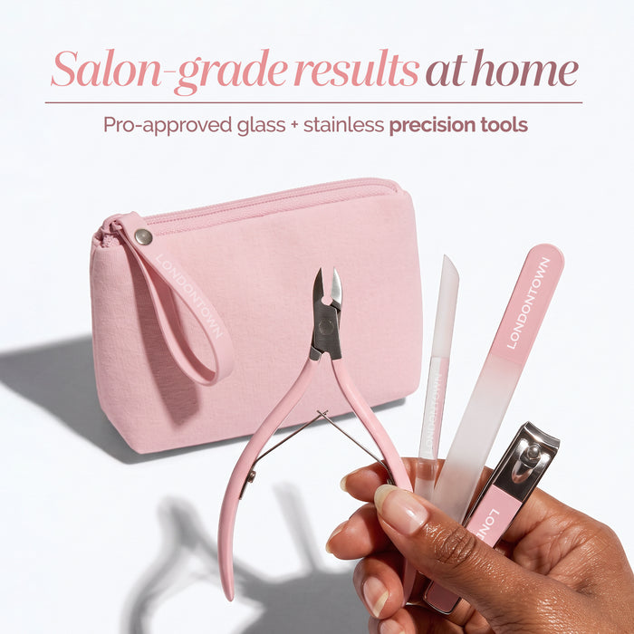A hand holds the LONDONTOWN Complete Nail Tool Set, showcasing precision nail tools—nail clipper, file, cuticle nipper, and buffer—all in a pink zippered pouch resting on a white background, ready to help you create the perfect canvas for your manicure.