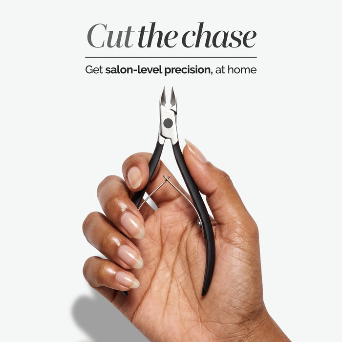 A hand holding LONDONTOWN’s Cuticle Nippers - Black, with the text “Cut the chase. Get salon-level precision, at home” above.