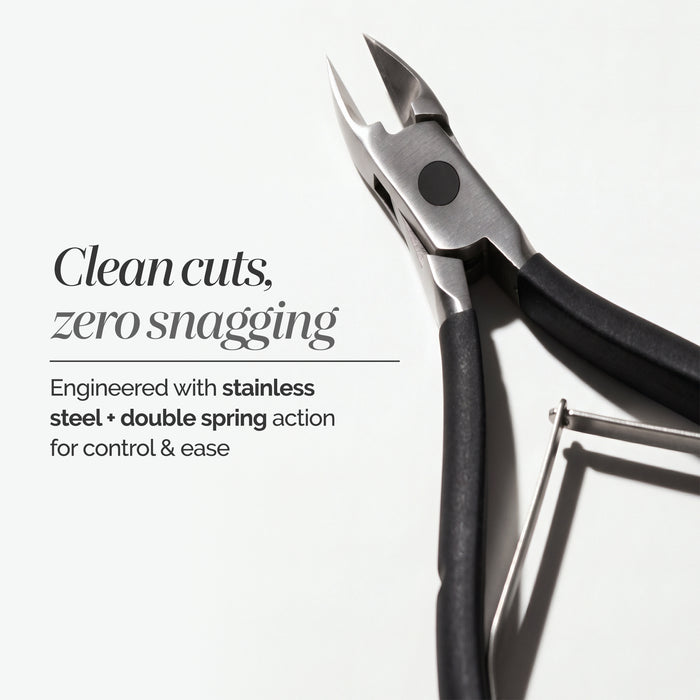 A pair of LONDONTOWN Cuticle Nippers - Black, featuring salon-grade stainless steel construction and sleek black handles, is displayed on a white surface alongside text outlining their key features.