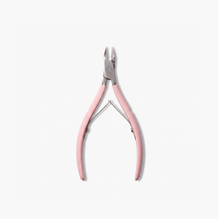 A pair of LONDONTOWN Cuticle Nippers in pink is displayed on a white background, offering salon-grade precision and effortless grooming.