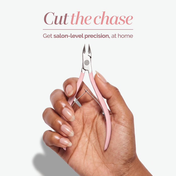 A hand with manicured nails holds LONDONTOWN Cuticle Nippers in pink; text above reads, “Cut the chase. Get salon-grade precision cutting, at home.”.