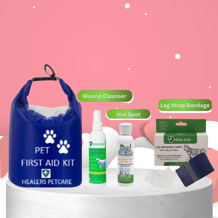Healers PetCare Pet First Aid Kit with blue waterproof bag, wound cleanser spray, natural hot spot and itch relief bottle, and leg wrap bandage with gauze pads on a white platform. Pink background with hearts and labels identifying items.