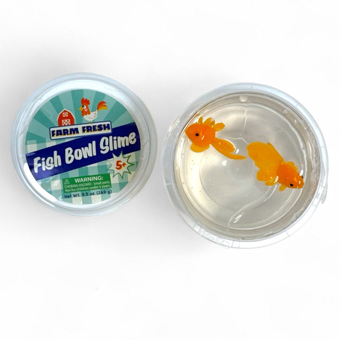 Two containers of Farm Fresh Fish Bowl Slime by Farm Fresh are shown. One is labeled, and the other is open, revealing clear slime with two small orange plastic goldfish inside.