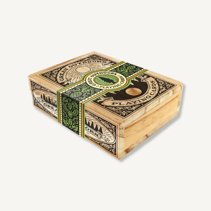 A wooden box with a label on it, containing Chronicle Books' Great Outdoors Playing Cards.