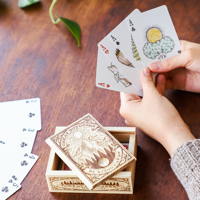 A wooden box with a label on it, containing Chronicle Books' Great Outdoors Playing Cards.