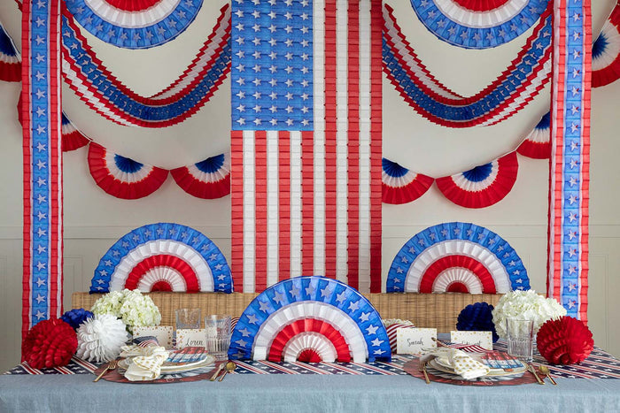 Patriotic honeycomb hanging from the walls and decorating a table.