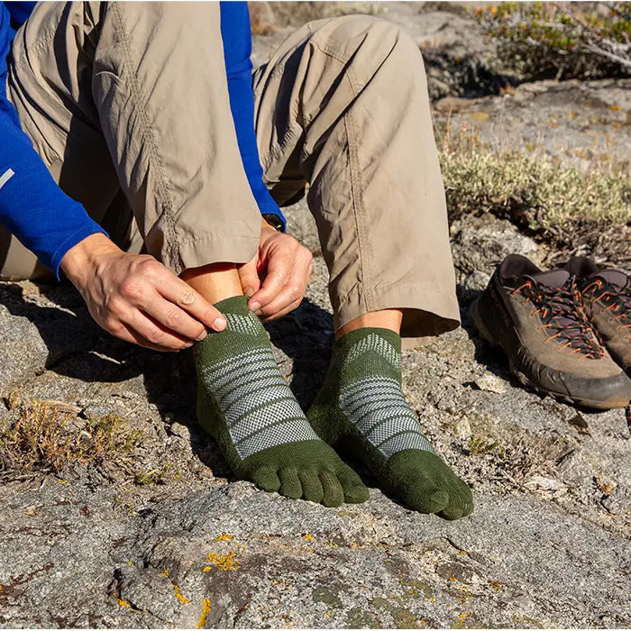 Injinji Toe Socks - Outdoor Midweight Wool - pulling on, trailside