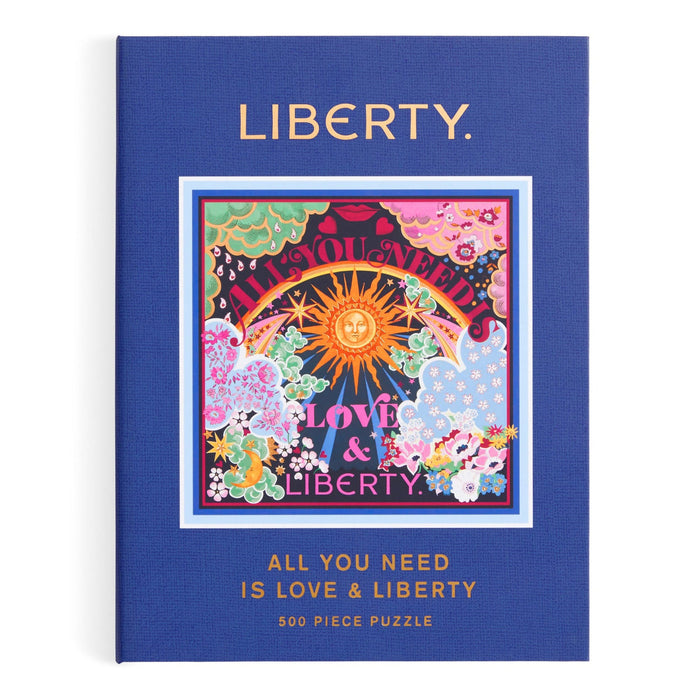 A jigsaw puzzle designed to look like a keepsake box with magnetic closure, titled "Liberty All You Need is Love Puzzle" featuring a colorful, Thorpe print design. It consists of the Liberty All You Need is Love 500 Piece Book Puzzle by Chronicle Books.