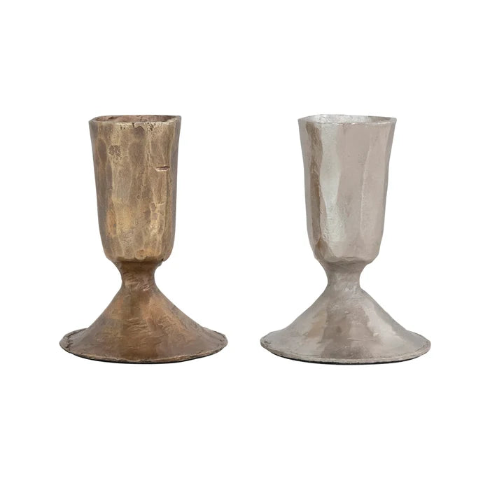 Two Creative Co-Op metal taper holders on a white background, one bronze one nickel.