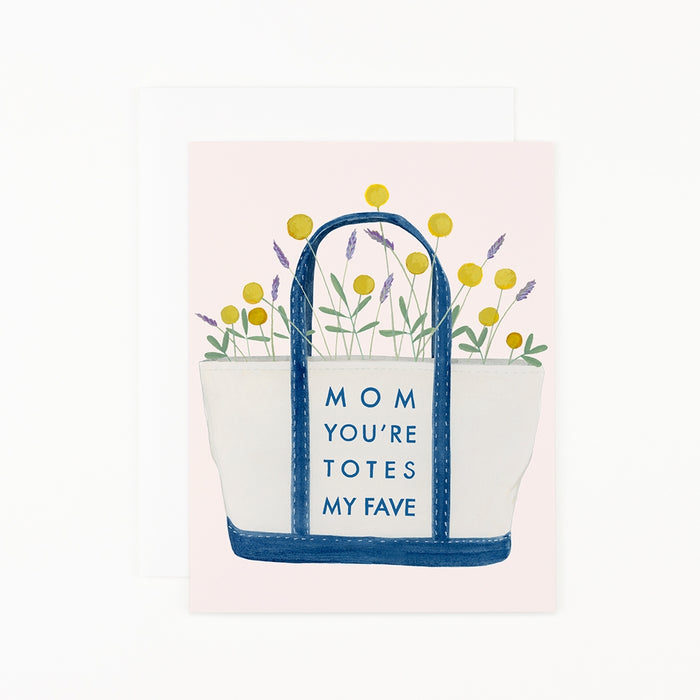 Illustration of a Mother's Day Totes Card by Dear Hancock featuring a tote bag with flowers and the phrase "mom you're totes my fave," accompanied by a matching soft white envelope.