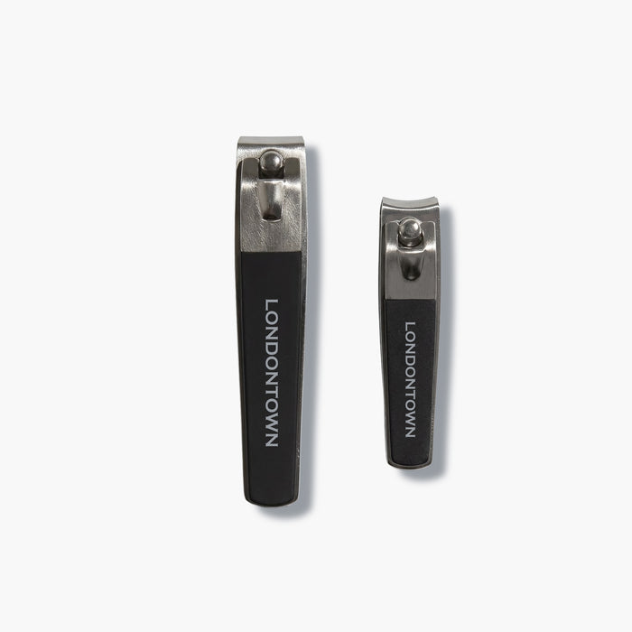 The LONDONTOWN Nail Clipper Duo Set - Black features two metal nail clippers with black handles, displayed side by side on a white background for a precise cut every time.