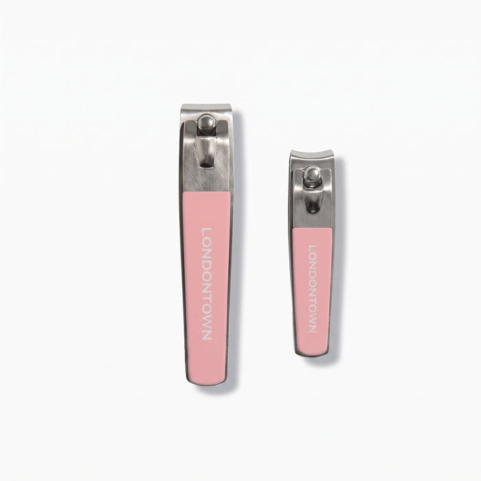 The LONDONTOWN Nail Clipper Duo Set - Pink features two metal nail clippers with pink grips, displayed on a white background. The set includes one large and one small clipper, both designed for precise, clean cuts and facing upward.
