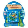 The On the Way Games Gone Fishin' travel game by On the Way Games features small plastic fish in a rotating pond, four green fishing poles, and colorful sea-themed packaging with visible warnings on the front.