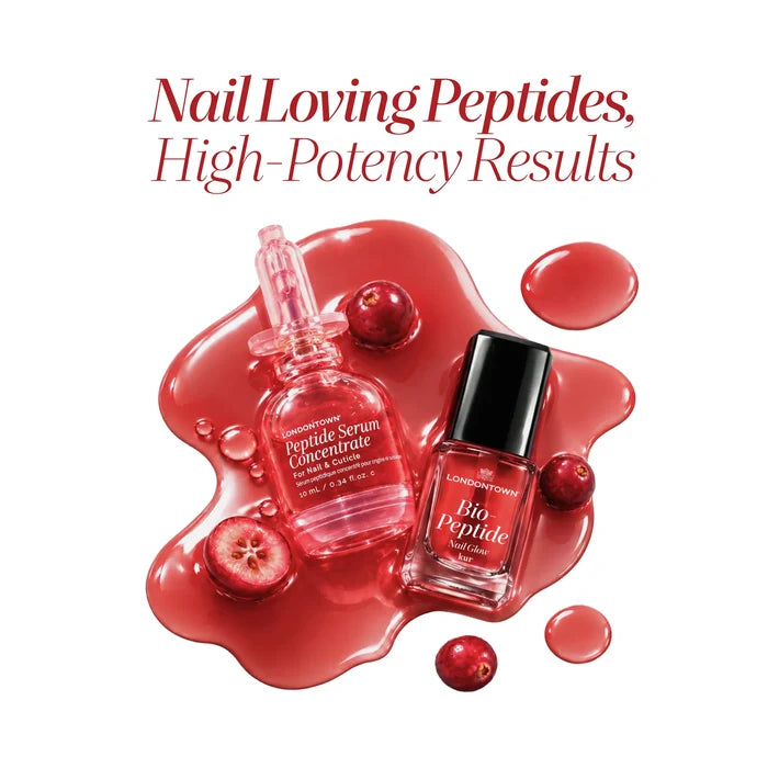 A bottle of LONDONTOWN Peptide Gloss Duo and a bottle of nail polish sit in a pool of red liquid surrounded by cranberries, with the text “Nail Loving Peptides, High-Potency Results” above.