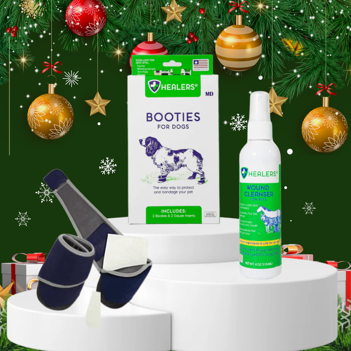 Healers holiday-themed display featuring Booties for Dogs packaging, a Wound Cleanser spray bottle, and two navy blue medical booties with gauze inserts, set against a festive Christmas background with ornaments and gifts.