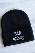 black beanie winter hat with sad songs in white font