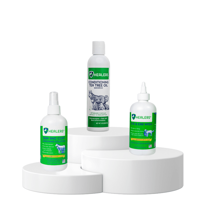 Healers PetCare grooming trio displayed on white podiums featuring Skin and Coat Soothing Solution, Conditioning Tea Tree Oil Shampoo, and Eye & Ear Wash.