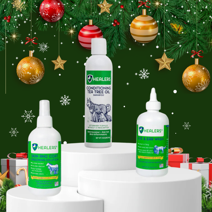 Healers PetCare holiday display with Skin and Coat Grooming Solution, Conditioning Tea Tree Oil Shampoo, and Eye & Ear Wash bottles showcased on white podiums with festive Christmas background.
