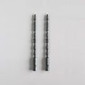 2 taper candles shaped like table spindle legs in slate.