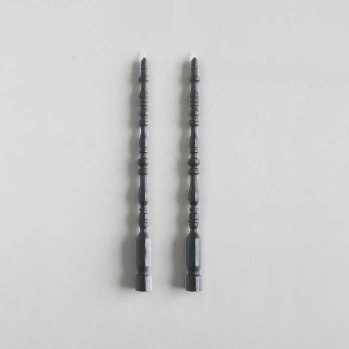 2 taper candles shaped like table spindle legs in slate.