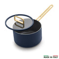 Blue ceramic saucepan with lid next to a Made in Italy label.