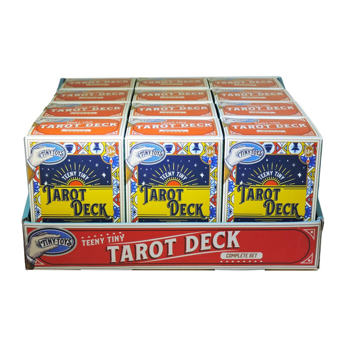 A display box holds multiple Tiny Toys Teeny Tiny Tarot Decks with colorful designs, arranged in three rows. The front reads "Tiny Toys Teeny Tiny Tarot Deck"—a perfect compact tarot for travel or readings on the go.