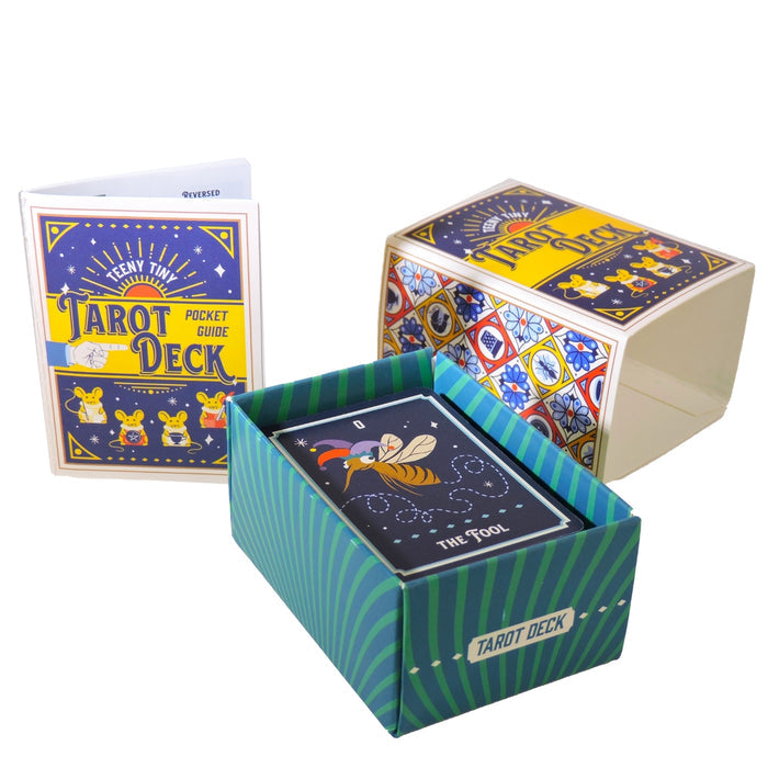 The Tiny Toys Teeny Tiny Tarot Deck by Tiny Toys features a striped blue and green box, The Fool card on top, a vibrant guidebook, and a decorative lid—ideal for travel tarot readings.