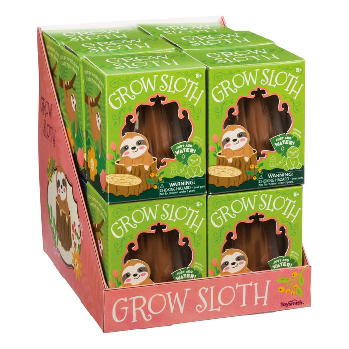 The Toysmith Grow Sloth display box contains eight novelty toys. Each features playful sloth illustrations on pink and green floral packaging, with instructions showing how the Toysmith sloth grows in water.