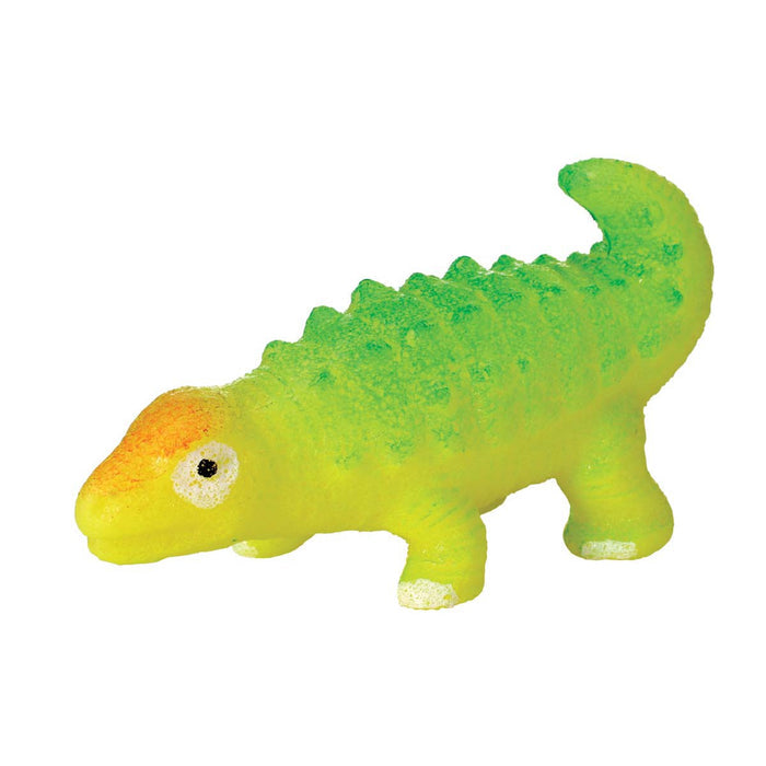 The Toysmith Hatchin' Grow Dino is a small, four-legged toy with bumpy green and yellow skin, an orange spot on its head, and white eyes with black pupils, displayed against a white background.