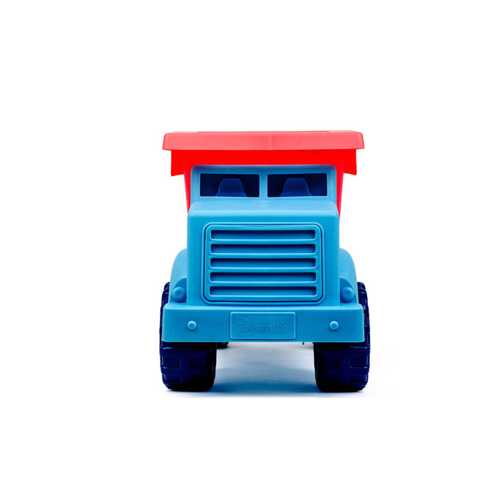 The Toysmith Large Dump Truck by Toysmith is a plastic toy truck with a red cab, blue body, and dark blue wheels, designed for outdoor play and shown from the front against a white background.
