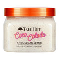front view of Tree Hut Coco Colada Shea Sugar Scrub 18oz in the newest packaging, clear tub with a dark orange lid against a clean white background