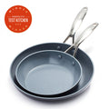 Two gray ceramic nonstick frypans with metal handles, overlapping beside an Americas Test Kitchen award.