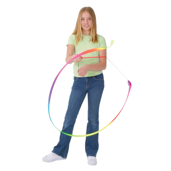 A girl in a green t-shirt and jeans twirls the YAY! Dance Ribbon by YAY!, creating a large loop in the air with creative movement against a white background.