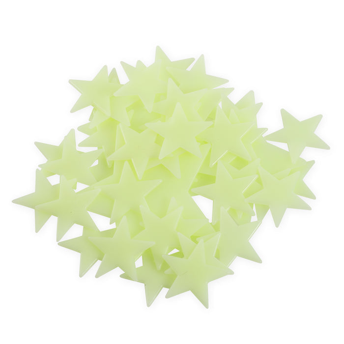 A collection of light green, glow-in-the-dark plastic stars from the Comic Book brand’s YAY! Glow Galaxy set is scattered on a white background, creating a space-inspired scene reminiscent of the Glow Galaxy.