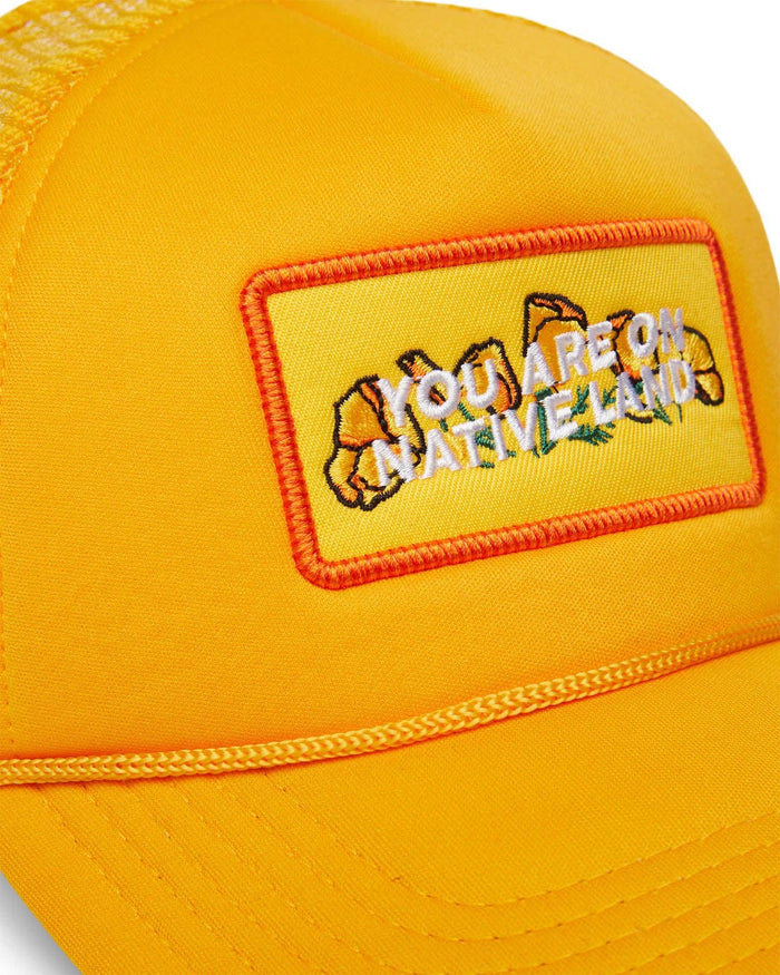 'YOU ARE ON NATIVE LAND' TRUCKER - MARIGOLD POPPY